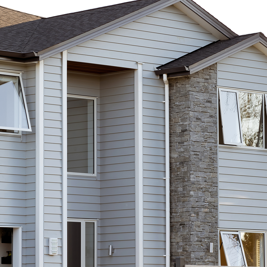 Grey Suburban House Needing Retrofit for Climate Change